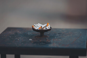 Street ashtray, the box is full of different cigarette butts, ecology. The collection of cigarette butts found in the outdoor ashtray on a public street. 