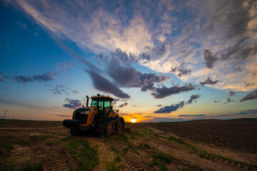 Tractor and Sunset In Colorado