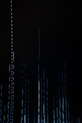 An abstract image featuring a digital glitch effect with horizontal white lines against a dark background, evoking a sense of distortion and interference. 
