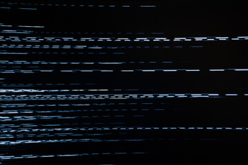 An abstract image featuring a digital glitch effect with horizontal white lines against a dark background, evoking a sense of distortion and interference. 