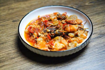 A plate of food with shrimp and red sauce
