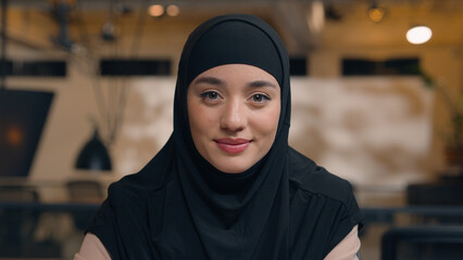 Arabian islamic muslim woman ethnic arabic girl female business lady in hijab smiling face thoughtful ponder think businesswoman student office employer happy positive looking at camera smile toothy