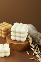 Beautiful bubble candles and spikes on brown table