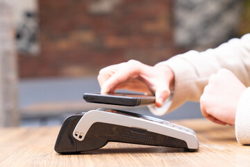 Smart phone, machine or hands of customer in cafe with cashier for shopping, sale or checkout.