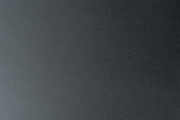 Close-up of smooth black surface under soft lighting