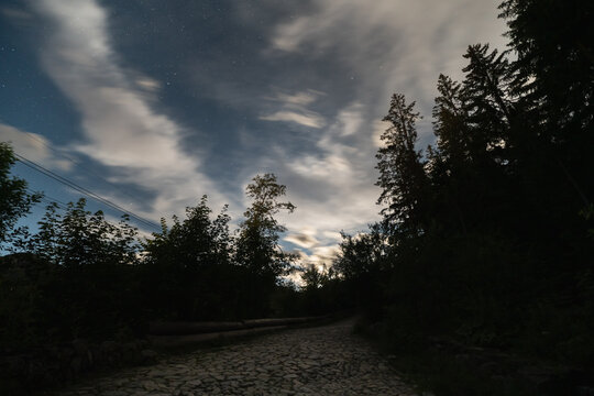 Landscape astrophotography, droga Brata Alberta in Polish mountains in Zakopane. Sky with clouds and stars.