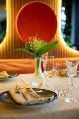 Elegant table setting with sunlight reflections creating a serene and warm dining experience