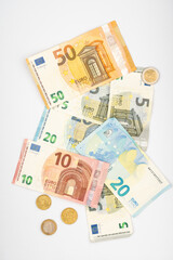 Euro banknotes and coins isolated on white background. Euro cash background. Background from several euro paper cash. 