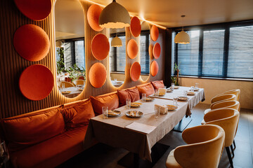 Sunlit restaurant table with elegant glassware, decor, and a warm, cozy ambiance