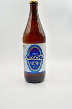 A closeup of a bottle of Reschs Pilsener isolated against a white background.