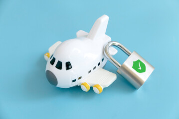 Securing Adventures: A Padlock with Shield and Checkmark Next to a Toy Airplane