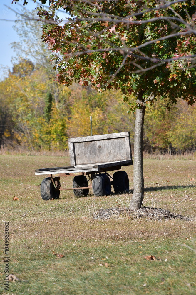 Poster Wooden Trailer by a Tree in a Field