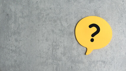 Q&A or questions and answers concept. yellow bubble speech written with question symbol over a gray background with copy space.