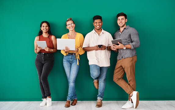 Happy people, portrait and waiting room with technology for career or job opportunity on a green wall background. Young, group or creative interns with smile in row or line for startup or interview