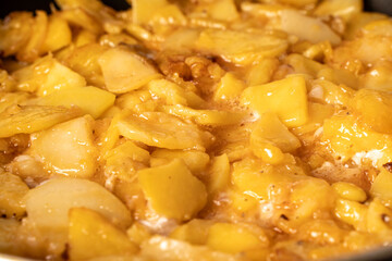 Potatoes are fried in a pan close-up. Background with potato texture