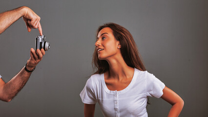 Photographer showing young woman how to use vintage camera