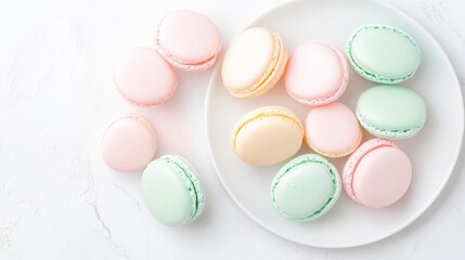 Obraz premium Delicate assortment of pastel macarons on white marble background