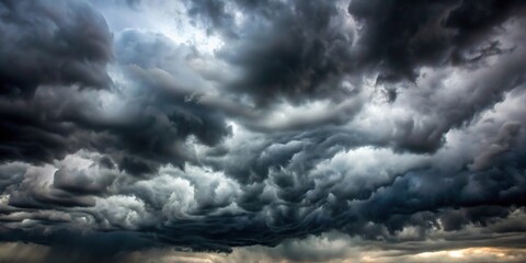 Obraz premium Clouds are thick and gray with dark shadows forming inside them., stormy, gray, thunderous, ominous