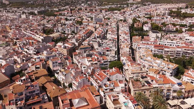 Aerial view of Sitges coastal village and Iglesia de San Bartolome y Santa Tecla during a sunny day