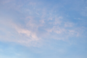 A beautiful sky tinted by the sun leaving vibrant shades of gold, pink, blue and multicolored. Clouds in the twilight evening and morning sky. Cloudy sky background in the evening, and during the day.