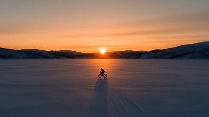 Fototapeta premium A scenic sunset ride on fat bikes by a frozen lake, serene and adventurous, capturing the essence of Global Fat Bike Day