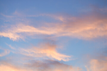 A beautiful sky tinted by the sun leaving vibrant shades of gold, pink, blue and multicolored. Clouds in the twilight evening and morning sky. Cloudy sky background in the evening, and during the day.