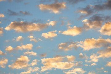 A beautiful sky tinted by the sun leaving vibrant shades of gold, pink, blue and multicolored. Clouds in the twilight evening and morning sky. Cloudy sky background in the evening, and during the day.