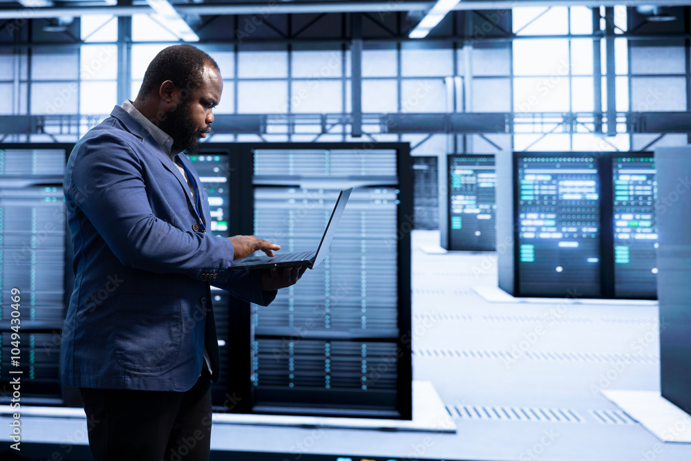 Poster computer scientist walking in data center, using laptop to configure network infrastructure such as 