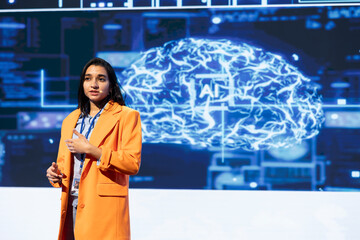 Technology company CEO using conference as platform to present latest AI services. IT expert uses...