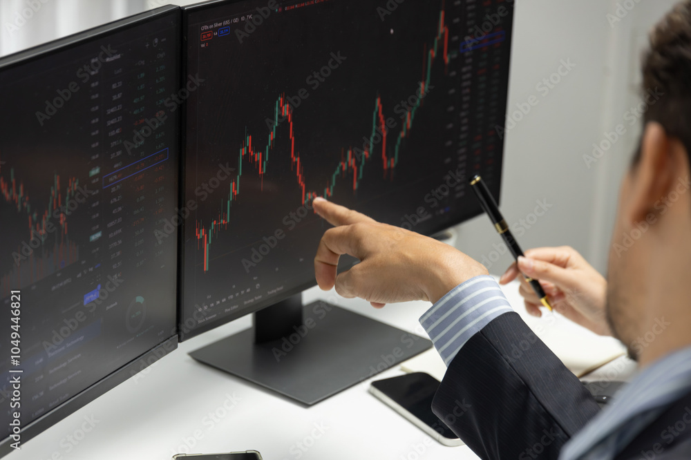 Poster focusing on hand pointing on pc screens with discussing dynamic stock market in two business traders