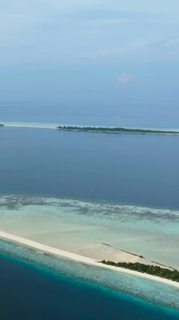 Top view of tropical islands on the atoll and coral reef. Timba Timba islet. Tun Sakaran Marine Park. Borneo, Sabah, Malaysia. Vertical video.