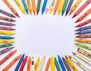 Fototapeta premium A Blank White Sheet of Paper With Colorful Pencils Around It