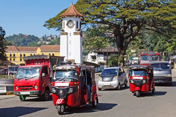 Tuk tuks and traffic in Kandy, Sr Lanka with the clock tower in the background