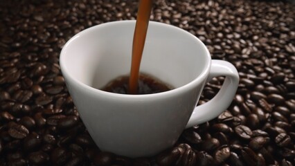 Freshly espresso was poured in white cup with pile of coffee bean. Pouring black coffee in the cup with brown background and seed scattering around on wooden table. Close up. Top view. Comestible.