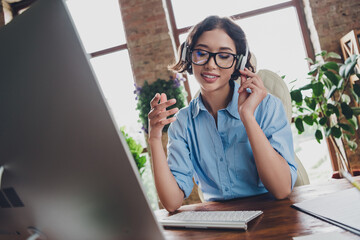 Photo of sweet charming lady assistant wear shirt eyeglasses headphones working modern device...
