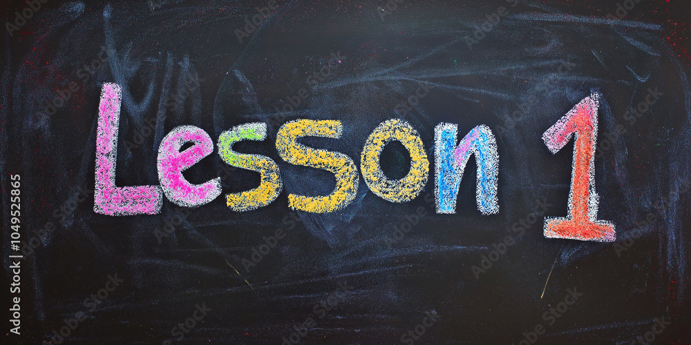 Aufkleber lesson 1 written on a blackboard with colorful chalk in a classroom