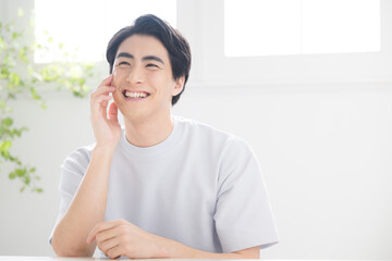 Beauty image close-up of young fresh man with hand on cheek taking care of skin, beard removal,...