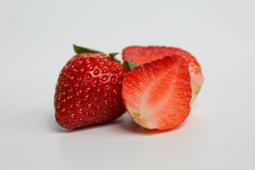 Halved fresh strawberries, isolated on white background