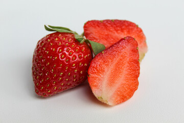 Halved fresh strawberries, isolated on white background