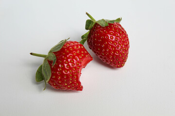 Bitten strawberry, isolated on white background