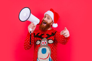 new year holiday. happy man announcing in loudspeaker about new year sales. man at new year