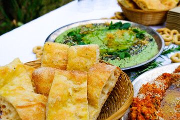 Brown bread on tray with green veggies beside