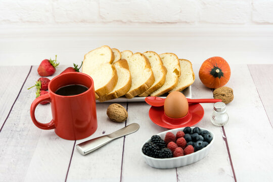 Breakfast spread with fresh bread, fruits, and coffee