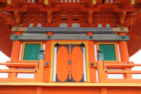 Orange wooden door with steel door lever on orange temple building