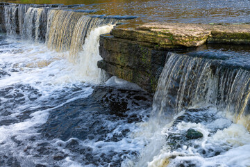 Fragment of Tosna waterfall on a October day. Leningrad region, Russia
