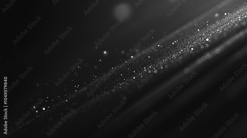 Poster a close-up view of shimmering particles on a dark surface illuminated by soft light