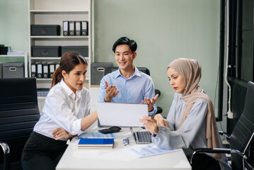 Office colleagues have a casual discussion. During a meeting in a conference room, a group of business teem