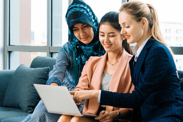 Multicultural working group. Team of businesswomen of different ethnicity, Caucasian, Asian and...