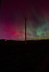 power lines at night with aurora