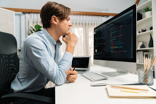 IT developer looking at online software development information on pc align working laptop with coding program on updated version application project trial creating new code overall system. Pecuniary.